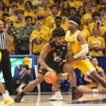 Miami Forard Norchad Omier works against Pitt’s Blake Hinson