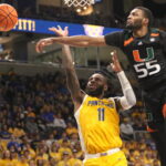 Miami’s Wooga Poplar blocks Jamarius Burton’a layup attempt in the 2nd half