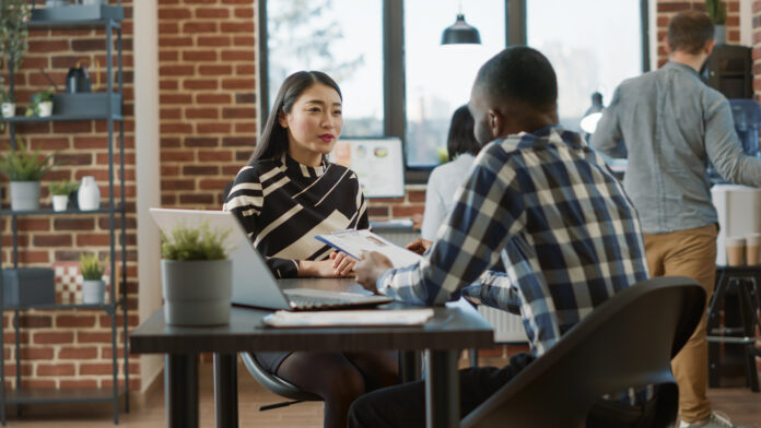 Male recruiter interviewing job seeker about work experience